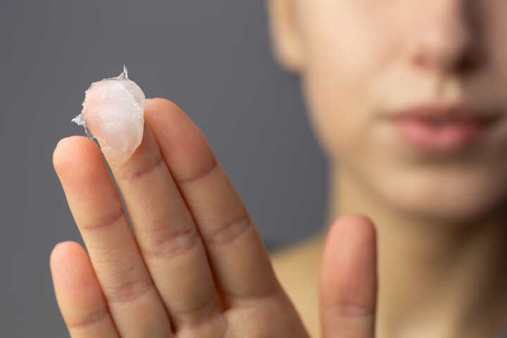 A woman with petroleum jelly on her fingers