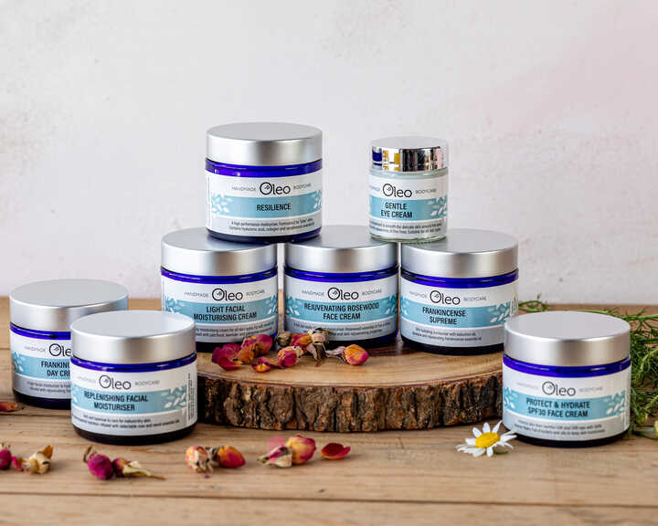 Oleo Bodycare range of award-winning vegan skincare laid on a wooden table