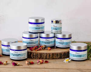 Oleo Bodycare range of award-winning vegan skincare laid on a wooden table