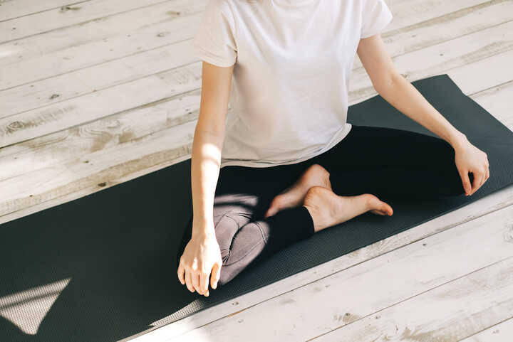 Woman meditating with essential oils to enhance relaxation