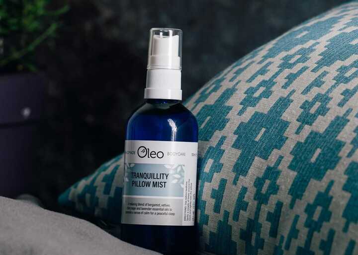 Oleo Bodycare Tranquility Pillow Mist propped up against a pillow