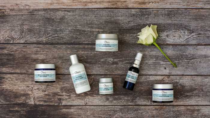 Range of vegan skincare products laid on a wooden table